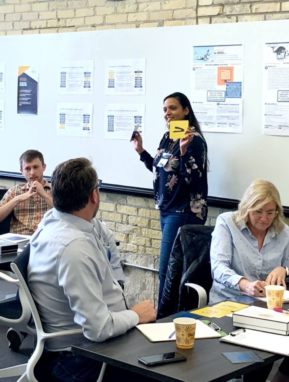 CDM team members having a discussion by a whiteboard